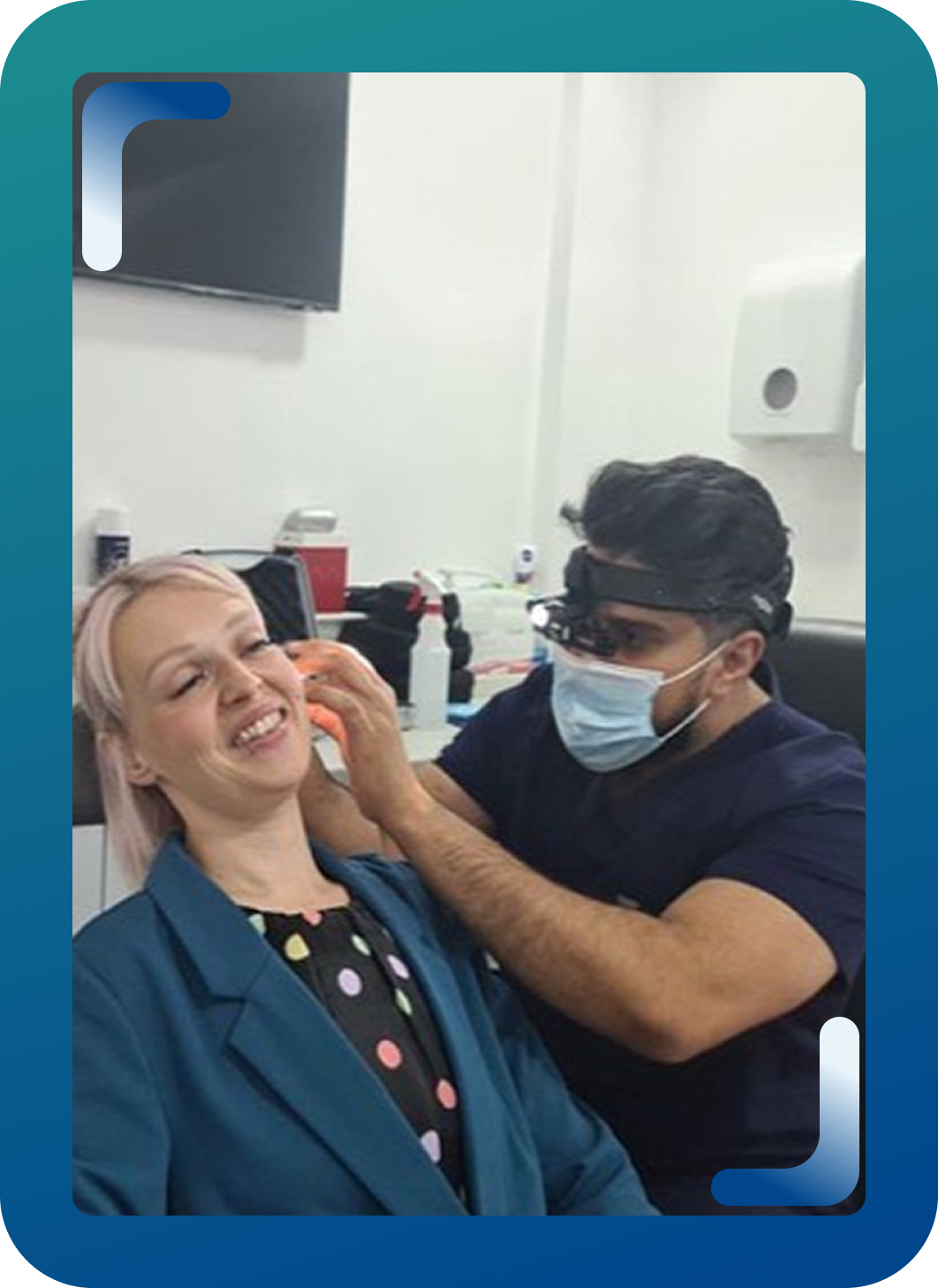 Ear care specialist using surgical loupes to examine a patient's ear.