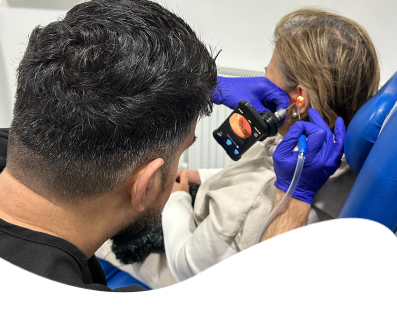 Audiologist performing endoscopic microsuction ear wax removal at our Sutton Coldfield clinic